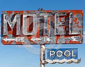 A dilapidated, vintage motel sign in the desert of Arizona