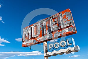 A dilapidated, vintage motel sign in the desert of Arizona