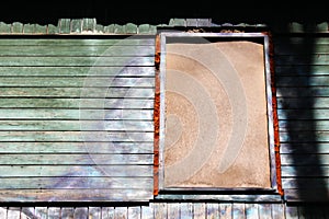 A dilapidated wooden abandoned house. Old building. Uninhabited house. a boarded-up window. No one