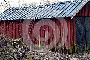 Dilapidated wooden building with rotten boards somewhere in Sweden