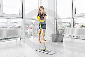 Little girl mopping floor