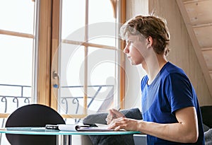 Diligent student doing homework using Tablet