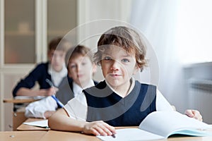 Diligent student sitting at desk, classroom