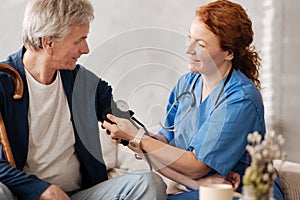Diligent trained doctor putting on a blood pressure sensor