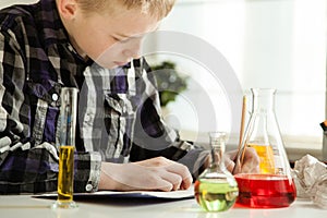 Diligent young boy doing his science homework