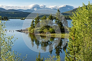 Dillon reservoir at sunrise, reflection of trees in water