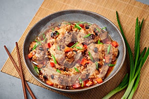 Dim Sum Pork Spare Ribs or Pai Guat in gray bowl on concrete table top. Chinese cantonese cuisine steamed spareribs dish photo