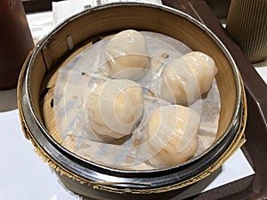 Dim Sum Steamed Shrimp Dumplings (Har Gow) in bamboo steamer. Yumcha, Cantonese food style. Chinese cuisine.