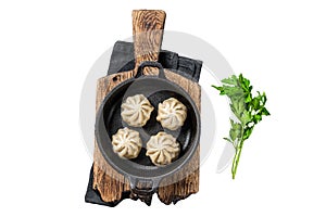 Dim sum stuffed meat dumplings in a pan with herbs Isolated on white background, top view.