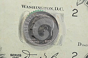 the dime coin, American money coin of 10 ten cents 1977 features the profile of Franklin D. Roosevelt the 32nd president of the photo