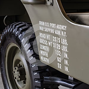 Dimensions and weights printed on the side of a military off road.