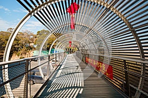 Diminishing Perspective View Of Empty Overpass With Protective Metal Fence on the mountain with red Chinese knots