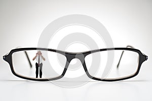 Diminutive elderly man peering through spectacles photo