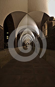 Dimly lit medieval cloister at night