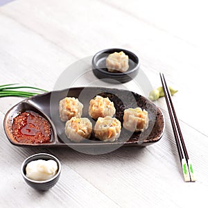 Dimsum is a Chinese Traditional Food, One of Varian Dimsum is Shicken Shiu May, serve with Chili Oil and Mayonaise