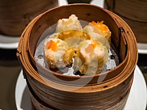 Dimsum Hagao in chinese bamboo basket traditional food in a restaurant. photo