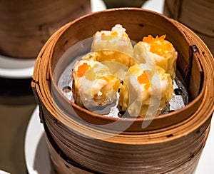 Dimsum Hagao in chinese bamboo basket traditional food in a restaurant. photo