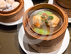 Dimsum Hagao in chinese bamboo basket traditional food in a restaurant.