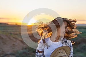 Dinamic shot woman with blowing hair on sunset in nature background, happy emotional girl