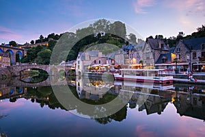 Dinan and Medieaval Stone Houses Reflecting in Rance River at Dusk in Summer in Bretagne, Cotes d`Armor, France photo