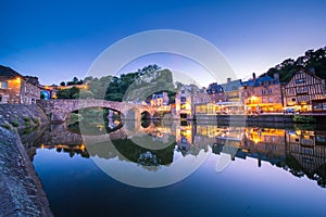 Dinan and Medieaval Stone Houses Reflecting in Rance River at Dusk in Summer in Bretagne, Cotes d`Armor, France photo