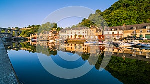 Dinan Stone Houses and Bridges Reflecting in Rance River at Sunrise in Bretagne, Cotes d`Armor, France.