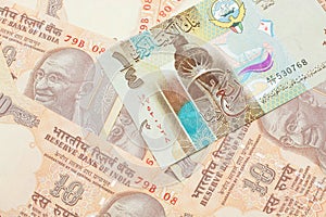 A dinar bank note from Kuwait with Indian ten rupee bank notes