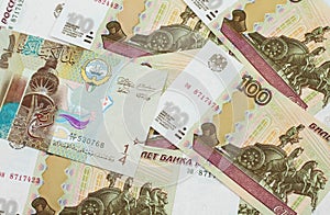 A dinar bank note from Kuwait with Russian one hundred ruble bills