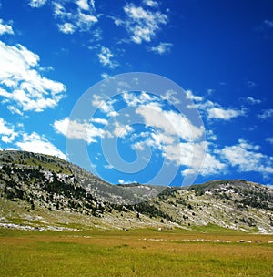 Dinara mountain over blue clouds 4