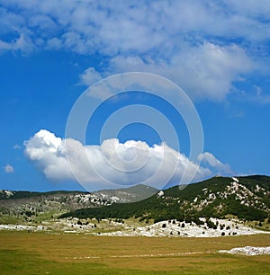Dinara mountain over blue sky