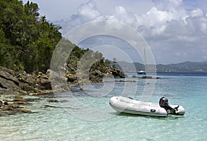 Dinghy anchored by shore