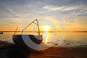 Dinghy on the beach at sunset