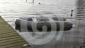 Dinghy inflatable boat in the water at a jetty in a northern German lake