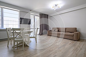 Dining or living room with white round dining table and sofa