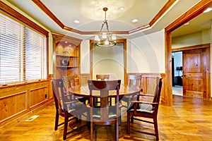 Dining luxury room with wood molding and floor.