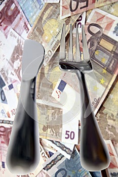 Dining out knife and fork isolated in money