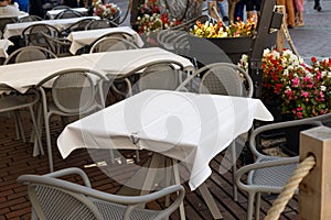 Dining outdoors. Outdoor street cafe tables ready for service. Empty cafe terrace with table and chair. Table of outdoor