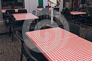 Dining outdoors. Outdoor street cafe tables ready for service. Empty cafe terrace with table and chair. Table of outdoor