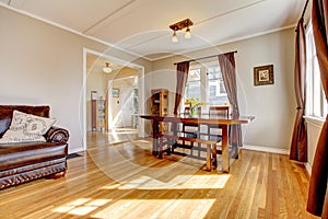 Dining room with brown curtain and hardwood floor.