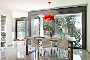 Dining room detail with design table and chairs in modern apartment