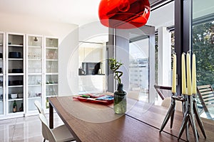 Dining room detail with design table and chairs in modern apartment