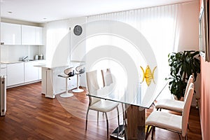 Dining room with glass table and leather chairs