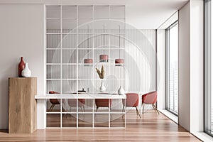 Dining room interior with table and chairs, red and white design, glass wall