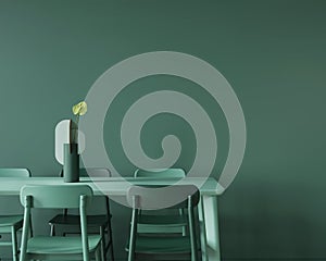 Dining room in monochrome green with a large table, chairs and a vase