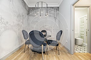 dining room with round glass table, capitone upholstered chairs
