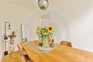 a dining room table with sunflowers on it