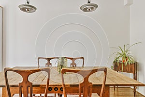 a dining room with a wooden table and chairs