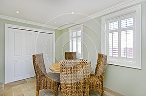 Dining room with wooden table and rattan chairs