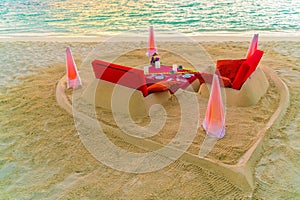 Dining table on beach at tropical Maldives island