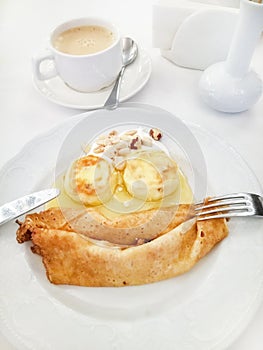 Dining table with breakfast, top view, pancakes with cheesecakes in the form of a funny face